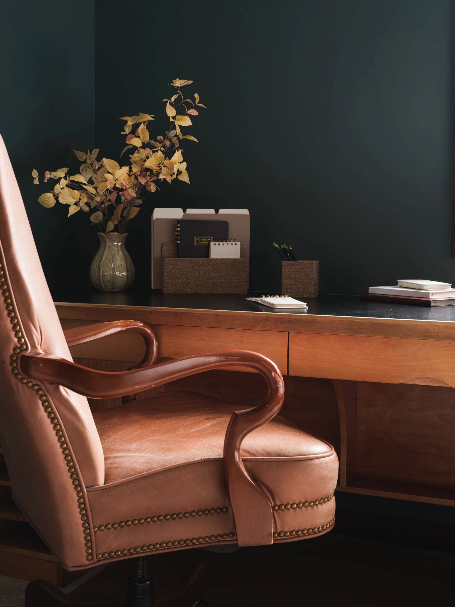 Leather office chair at a wood desk in a dark green home office — interior design photography Livingston Montana, Bear Canyon Ranch